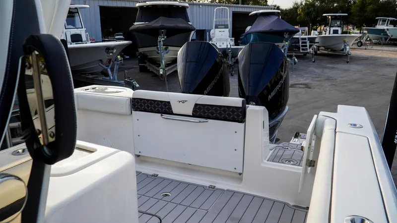 Slide: The Image of 2023 Tidewater 320 CC Adventure boat with dual engines in a marina setting. - 6