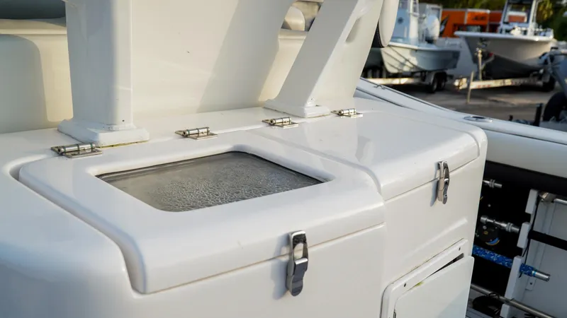 Slide: The Image of 2023 Tidewater 320 CC Adventure boat with sleek white deck and storage compartments. - 7
