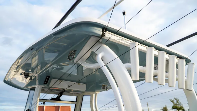 Slide: The Image of 2023 Tidewater 320 CC Adventure boat with sleek design and rod holders. - 9