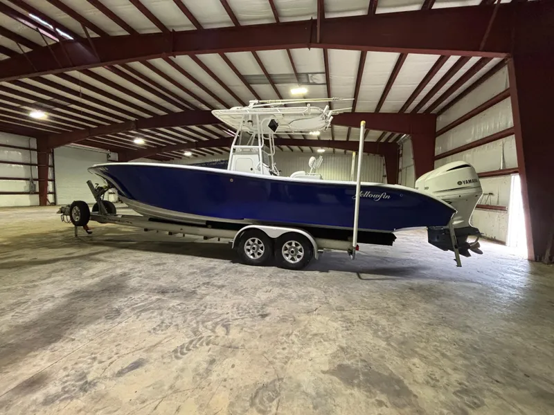 Slide: The Image of 2001 Yellowfin 31 boat in a spacious indoor storage facility. - 1