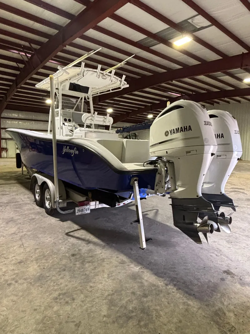 Slide: The Image of 2001 Yellowfin 31 boat with twin Yamaha engines in a warehouse. - 2