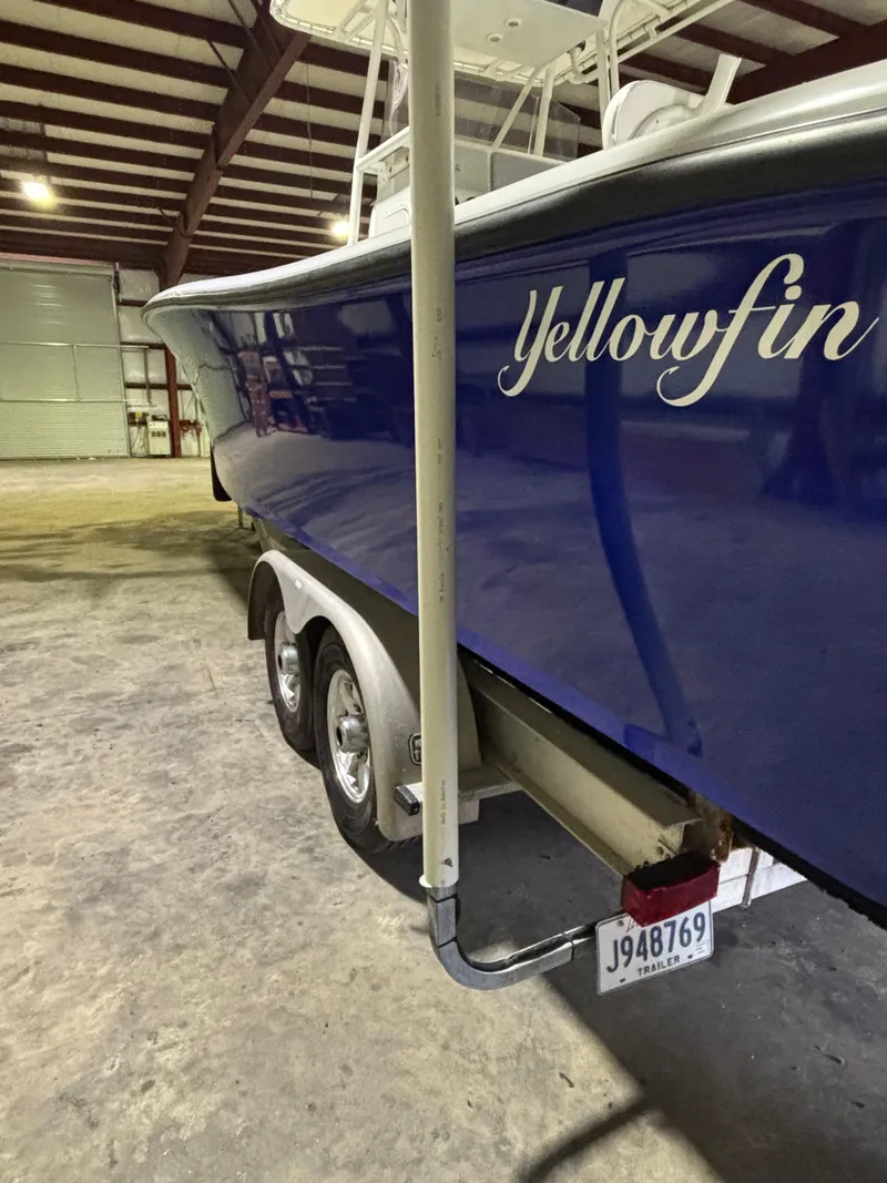 Slide: The Image of 2001 Yellowfin 31 boat in storage, blue hull, dual-axle trailer. - 3