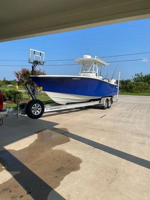 Slide: The Image of 2001 Yellowfin 31 boat on trailer, parked outdoors under clear blue sky. - 4