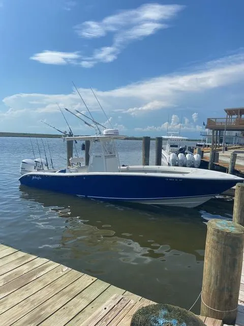Slide: The Image of 2001 Yellowfin 31 boat docked under a clear blue sky. - 5