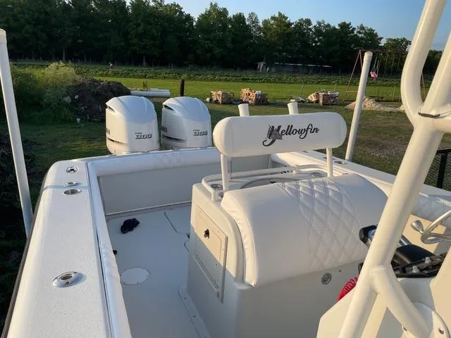 Slide: The Image of 2001 Yellowfin 31 boat with dual engines, white seating, and open deck. - 8