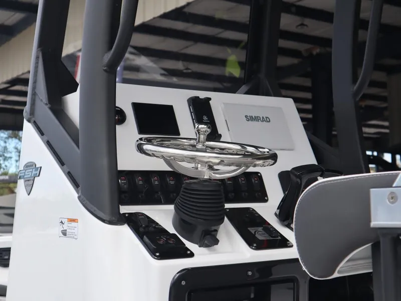 Slide: The Image of 2025 Yamaha Boats 222 FSH Sport E dashboard with steering wheel and controls. - 15
