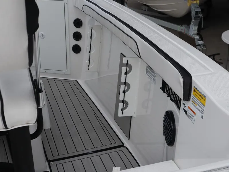 Slide: The Image of 2025 Yamaha Boats 222 FSH Sport E interior with rod holders and sleek design. - 19