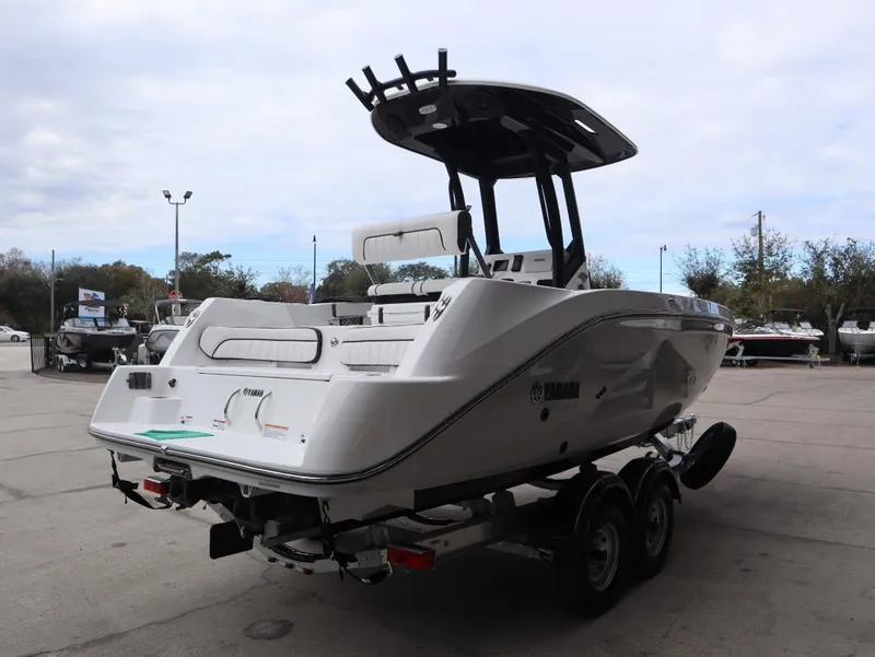 Slide: The Image of 2025 Yamaha Boats 222 FSH Sport E on trailer, rear view in outdoor setting. - 6