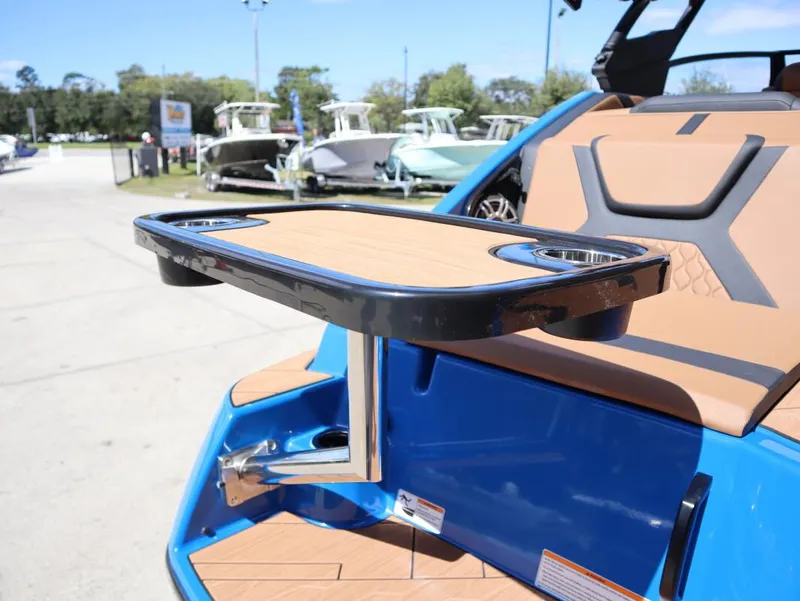 Slide: The Image of Yamaha Boats 2025 222XD with sleek seating and table, docked outdoors. - 11