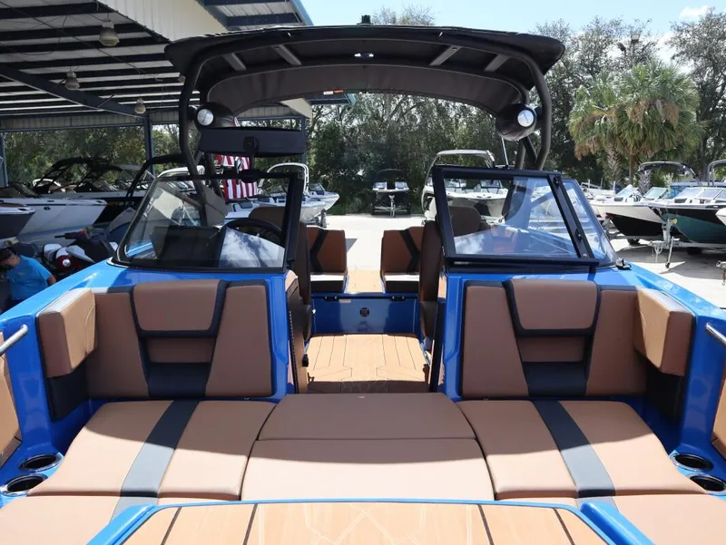 Slide: The Image of 2025 Yamaha Boats 222XD interior with tan seating and blue accents. - 15