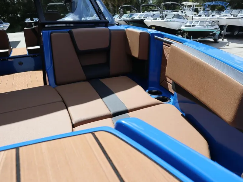 Slide: The Image of 2025 Yamaha Boats 222XD interior with tan seating and blue accents. - 17