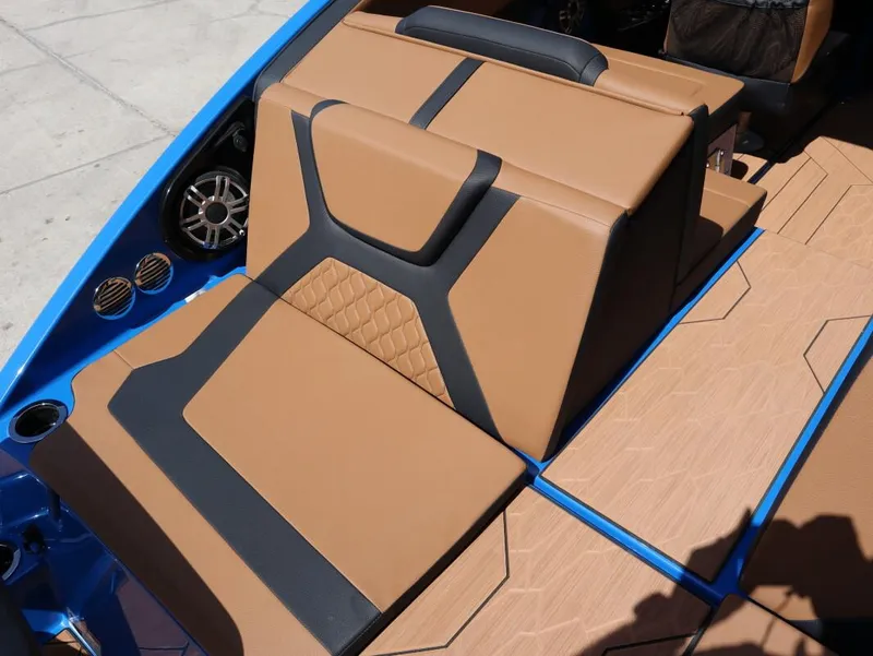 Slide: The Image of 2025 Yamaha Boats 222XD interior with tan and black seating, blue accents, and speaker system. - 20