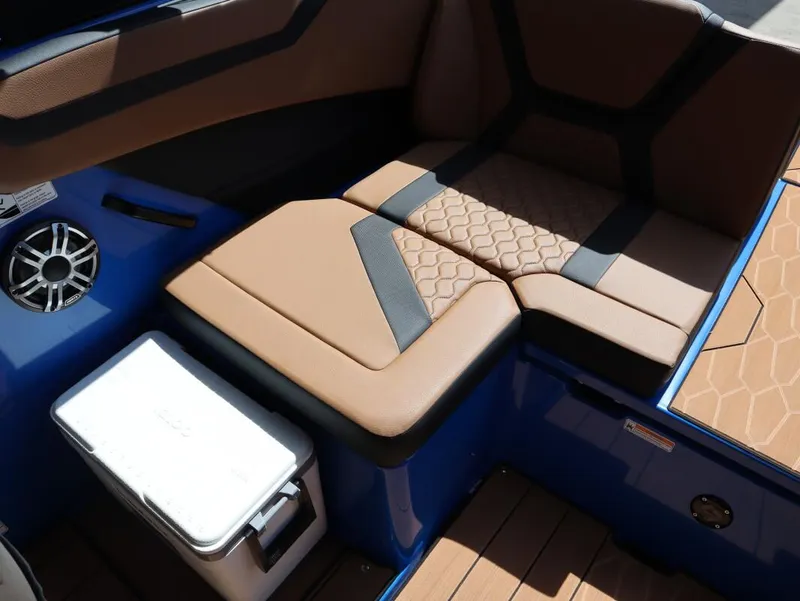 Slide: The Image of 2025 Yamaha Boats 222XD interior seating with tan upholstery and integrated speaker. - 22