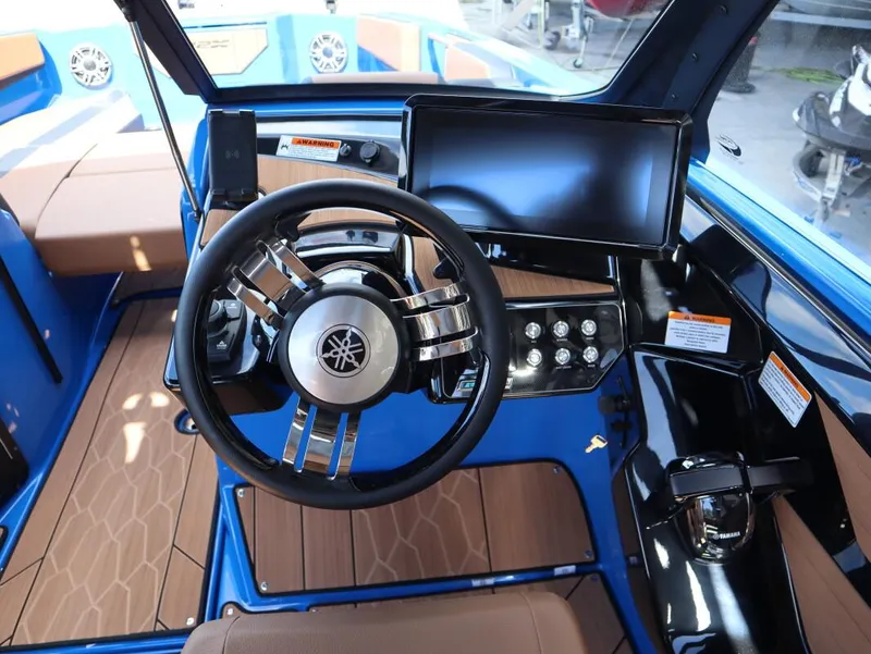 Slide: The Image of 2025 Yamaha Boats 222XD cockpit with modern steering wheel and digital display. - 23