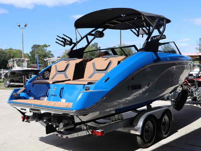 Slide: The Image of 2025 Yamaha Boats 222XD in blue on trailer, rear view. - 4