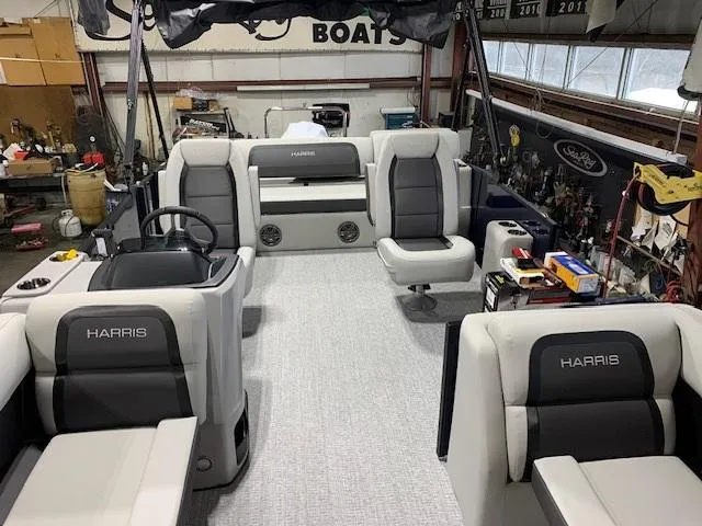 Slide: The Image of 2025 Harris Cruiser 210 boat interior with modern seating and steering wheel. - 2