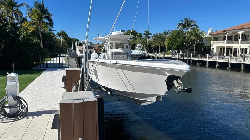 The Image of 2021 Blackwater 36 SF boat docked by waterfront homes under clear blue sky. - 1