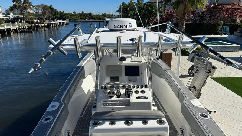 Slide: The Image of 2021 Blackwater 36 SF boat with advanced Garmin navigation, docked by a scenic waterfront. - 11