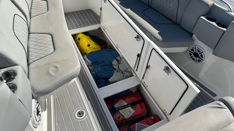 Slide: The Image of Open storage compartments on a 2021 Blackwater 36 SF boat, revealing life jackets and gear. - 16