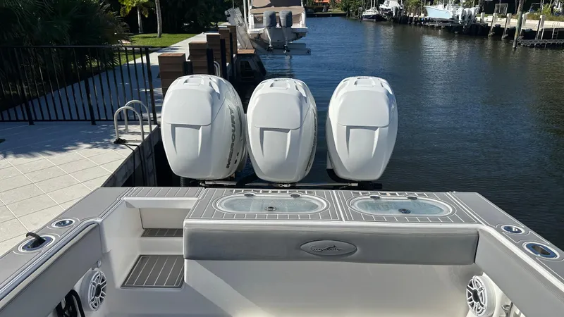 Slide: The Image of 2021 Blackwater 36 SF boat with triple outboard engines docked by a canal. - 20