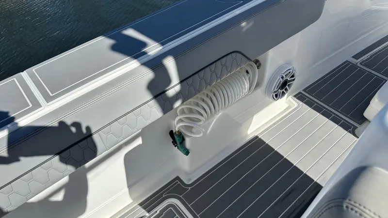 Slide: The Image of 2021 Blackwater 36 SF boat deck with coiled hose and speaker. - 7