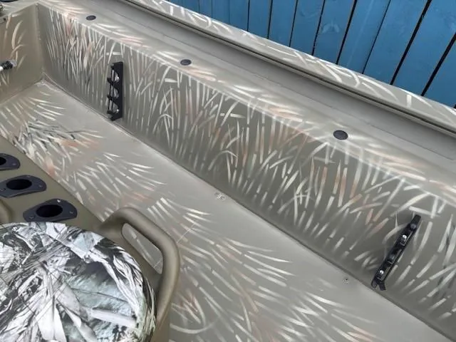 Slide: The Image of 2024 Tracker Grizzly 1860 CC boat interior with camouflage design. - 12