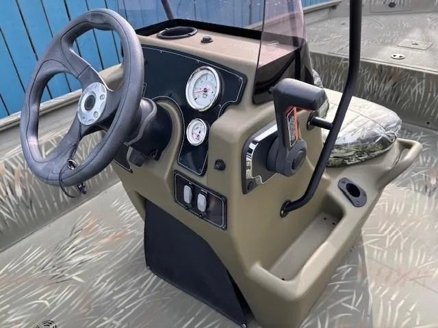 Slide: The Image of 2024 Tracker Grizzly 1860 CC boat console with steering wheel and gauges. - 15