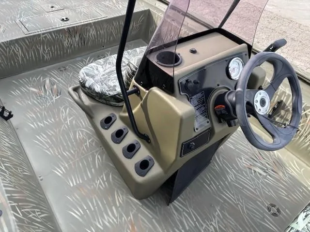 Slide: The Image of 2024 Tracker Grizzly 1860 CC boat console with steering wheel and camo seat. - 16