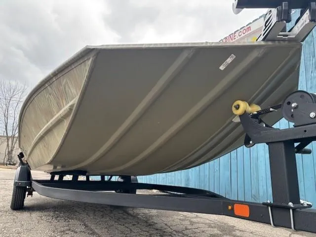Slide: The Image of 2024 Tracker Grizzly 1860 CC boat on trailer, viewed from below, against blue wall. - 3