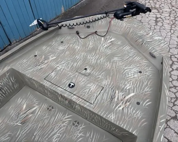 Slide: The Image of 2024 Tracker Grizzly 1860 CC boat deck with camouflage pattern and trolling motor. - 7