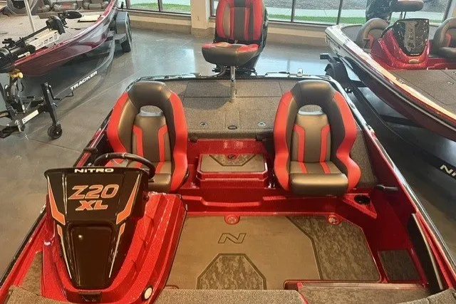Slide: The Image of 2025 Nitro Z20 XL Pro boat interior with red and gray seating, showroom display. - 129