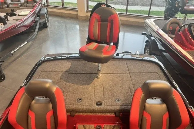 Slide: The Image of 2025 Nitro Z20 XL Pro boat interior with red and black seating in showroom. - 128