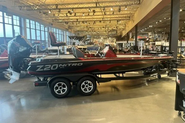 Slide: The Image of 2025 Nitro Z20 XL Pro boat displayed in a showroom, featuring sleek design and dual-axle trailer. - 120