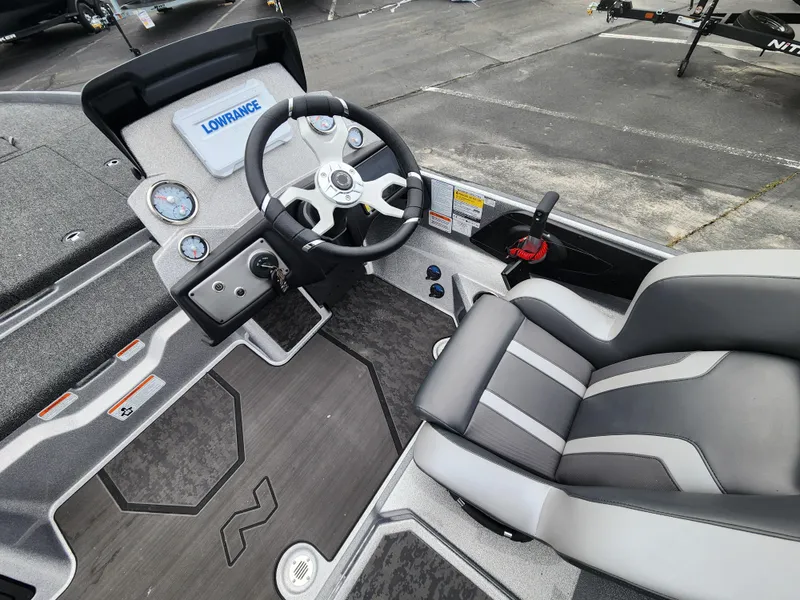 Slide: The Image of 2025 Nitro Z21 XL boat interior with steering wheel and seating. - 2