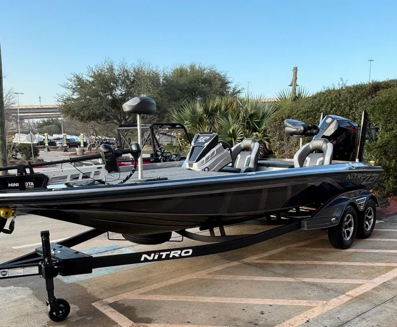 The Image of 2025 Nitro Z21 XL boat on trailer, parked outdoors, showcasing sleek design and modern features. - 0
