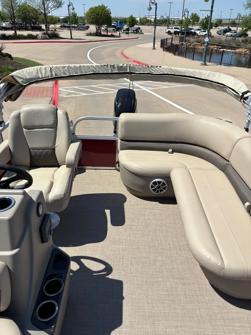 Slide: The Image of 2025 Sun Tracker Bass Buggy 16 XL Select pontoon boat with beige seating and modern design. - 4