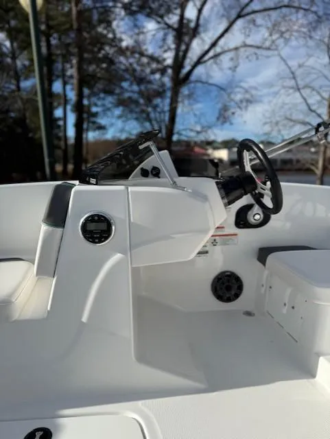 Slide: The Image of 2025 Tahoe T16 boat interior with steering wheel and control panel, set against a natural backdrop. - 45