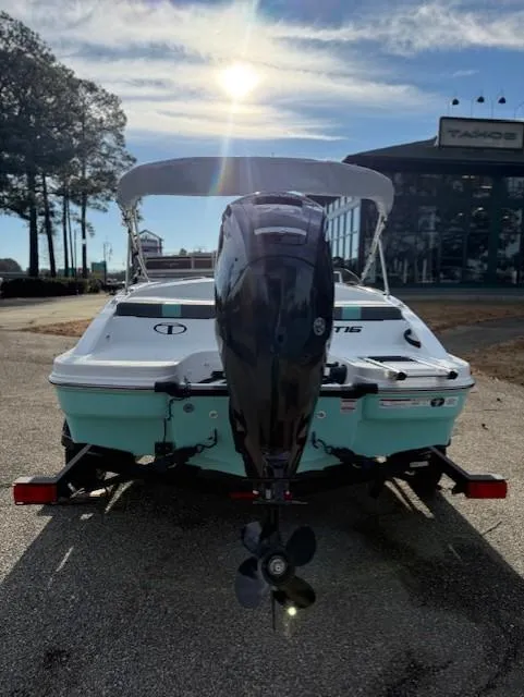 Slide: The Image of 2025 Tahoe T16 boat with outboard motor, parked outdoors under a sunny sky. - 46