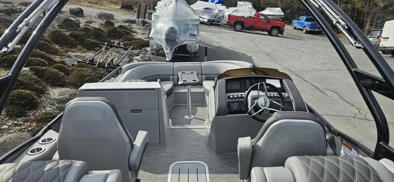Slide: The Image of 2024 Bennington R 24 RTFBA pontoon boat interior with modern seating and steering console. - 11