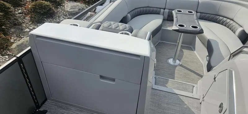 Slide: The Image of 2024 Bennington R 24 RTFBA boat interior with gray seating and table. - 3