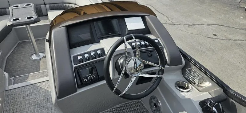 Slide: The Image of 2024 Bennington R 24 RTFBA boat dashboard with steering wheel and control panel. - 4