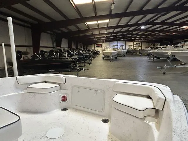 Slide: The Image of 2025 ALK2 Boats 22 CRS in a spacious indoor showroom. - 3