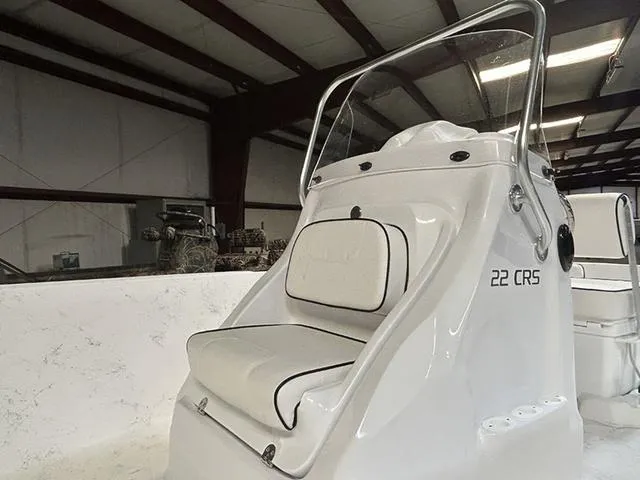 Slide: The Image of 2025 ALK2 Boats 22 CRS model, white interior, sleek design in warehouse setting. - 7