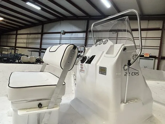 Slide: The Image of 2025 ALK2 Boats 22 CRS interior with white seating and control panel. - 9