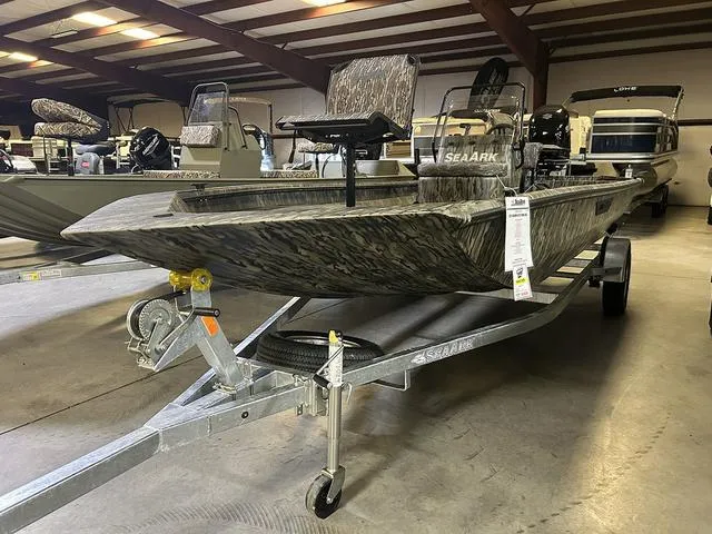 Slide: The Image of 2025 SeaArk Shadow 18 T Center Console boat on trailer in showroom. - 1
