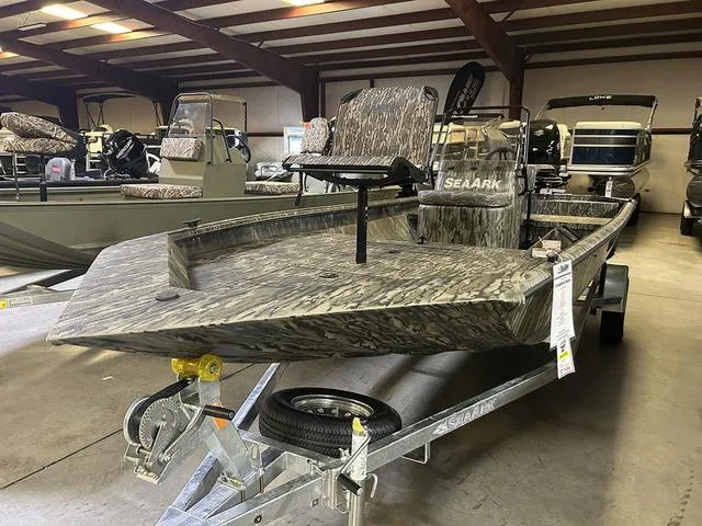 Slide: The Image of 2025 SeaArk Shadow 18 T Center Console boat in showroom, camo design, on trailer. - 10