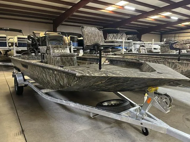Slide: The Image of 2025 SeaArk Shadow 18 T Center Console boat on trailer in showroom. - 2