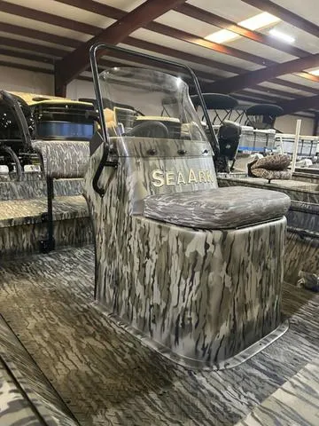 Slide: The Image of 2025 SeaArk Shadow 18 T Center Console boat with camouflage design in showroom. - 4