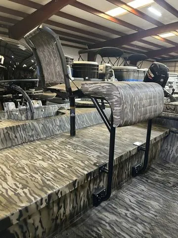 Slide: The Image of 2025 SeaArk Shadow 18 T Center Console with camo seating and interior design. - 6