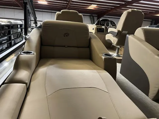 Slide: The Image of 2023 Lowe Retreat 230 RFL TLX boat interior with beige seating and cup holders. - 8